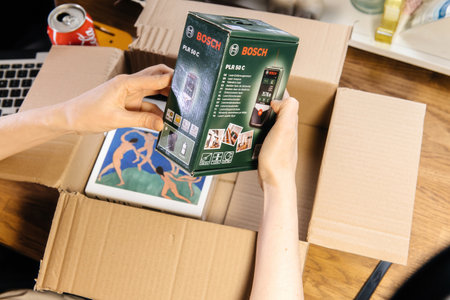 unpacking new carboard box unveiling Bosch electronic laser measure model PLR 50 Cのeditorial素材