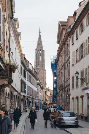 View of French city of Strasbourg with pedestrians walking sightseeing and Notre-Dameのeditorial素材