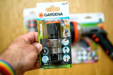 Male hand holding new Gardena Premium Hose Connectorのeditorial素材