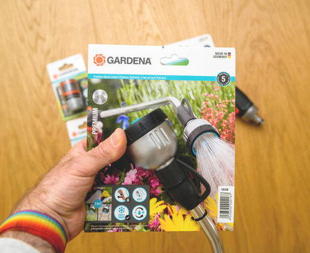 POV male hand holding new Premium Spray Lance from Gardena Germany with Article No. 18336-20のeditorial素材