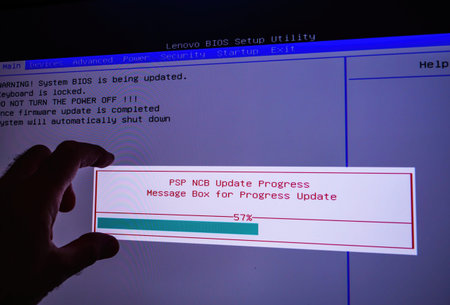 POV male hand on the touchscreen display during bios update of Lenovo computer workstation