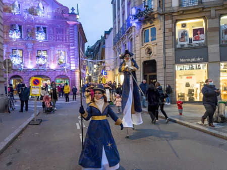 Christmas atmoshpere in Strasbourg, capital of the winter holidays with stilt walker illuminator of the Christmas events -のeditorial素材