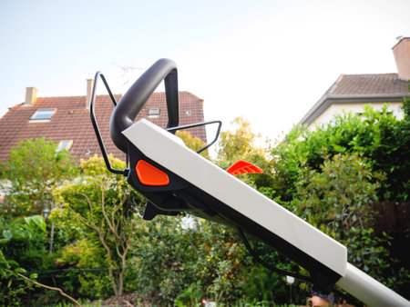 Side view of lawn mower handle with multiple buttons