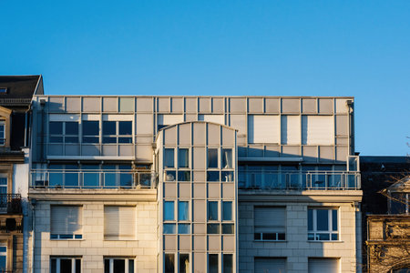 Warm sun over modern French apartment building with balconies terrace