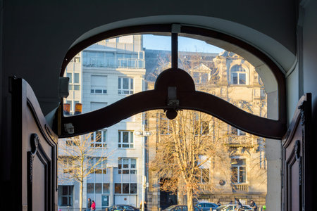 View of French apartment building seen through the open gate