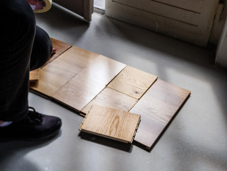 Overhead view of women choosing multiple wooden floor parquet flooring from diverse manufacturer and diverse nuances in her new houseの写真素材