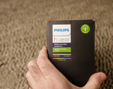 OV male hand unboxing unpacking new Philips Signify HUE white an
