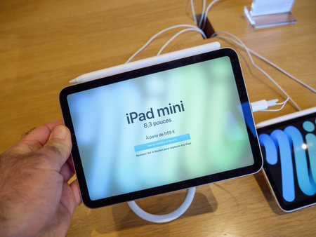 holding from above at the new iPAd Mini pro tablet computer manufactured by Apple Computersのeditorial素材