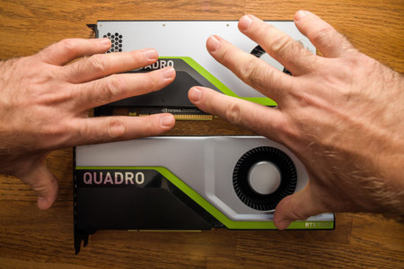 Senior and young engineer hands pov holding looking at two new GPU Nvidia Quadro RTX 4000 RTX 5000