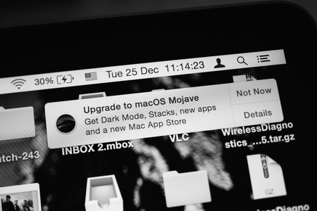 Black and white image close-up view of Upgrade to MacOs Mojave signage on the Apple Computers...