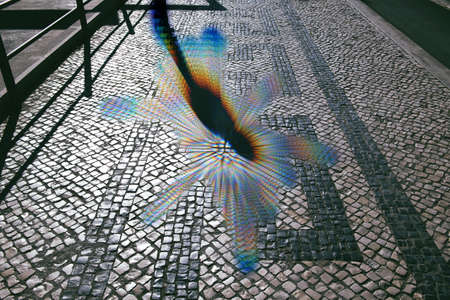 Metaverse digital silhouette shadow of person on the cobblestone road - conceptual reality imagination virtual and real world - cybersapce hypothesized iteration of the internet, supporting persistent online 3-D virtual environmentsの写真素材