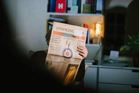 Woman reading British Financial Times newspaper with the cover headline EU prepares gas options if Ukraine crisis hits suppliesのeditorial素材