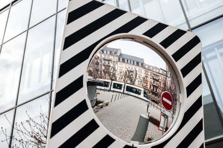 Reflection of French tramway in the safety security mirror for cyclists in central Strasbourgの写真素材