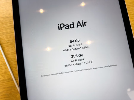 Close-up of new iPad Air 5 tablet with prices for 64 gb and 256 gb wi-fi cellular during launc sales...