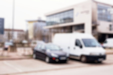 Deocused view of cars parked in front of the building