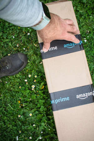 POV male hand holding preparing to unboxのeditorial素材