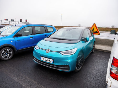 new VW Volkswagen ID3 electric EV vehicle parked next to gas Dacia Stepway car
