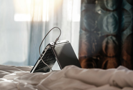 Laptop on the bed with USB charging portの写真素材