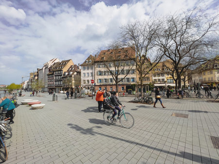 Pedestrians walking on the Place du Corbeau with Quai des Bateliers promenade street in background - sightseeing Strasbourgのeditorial素材