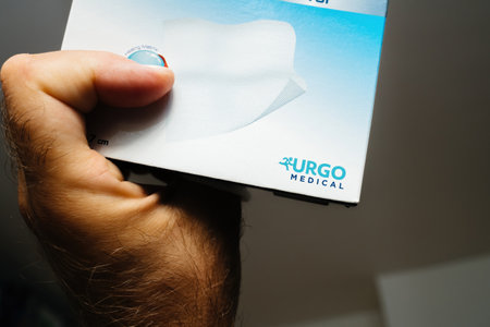 OV male hand close-up holding package with Urgo Medicalのeditorial素材