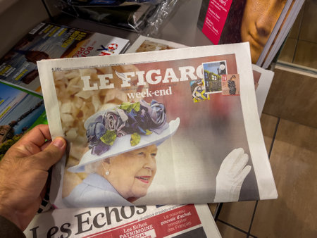 Press kiosk hand reading Le Figaro newspaper paying tribute to tのeditorial素材