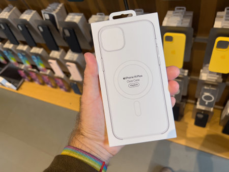 POV male hand holding package in Apple Store shopping with new iのeditorial素材