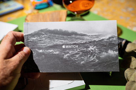 Man unboxing package of new titanium Apple Watch Ultra designed for extreme activities like endurance sports, elite athletes, trailblazing, adventureのeditorial素材