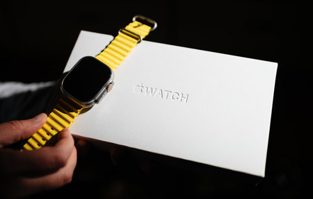 Woman holding new Apple Computers Apple Watch Ultra next to its innovative packagingのeditorial素材