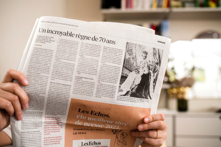 Woman reading latest Les Echos business newspaper cover page payのeditorial素材