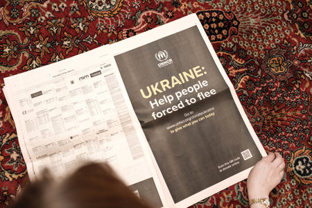 Woman reading on living room floor carpet latest Financial Timesのeditorial素材