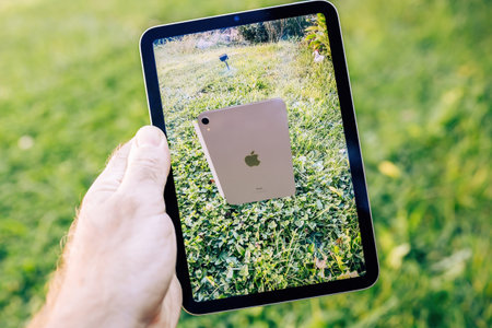 AR view of new ipad mini on the display of an ipad Mini Pro in green gardenのeditorial素材