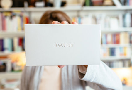 POV woman holding new white cardboard package of new Apple Watch Ultra titanium by Apple Computersのeditorial素材