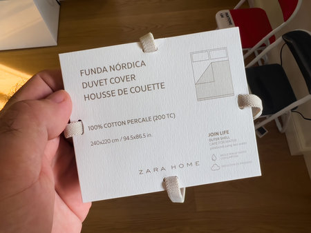 POV male hand holding Duvet Cover package by Zara Home Inditex