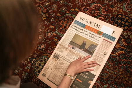 View from above woman reading Financial Times newspaper with covのeditorial素材