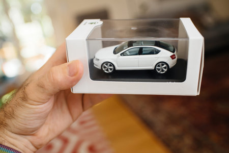 POV Male hand holding new Skoda Vision presentation for scale car model