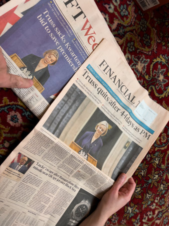 View from above of woman reading in living room floor the frontのeditorial素材