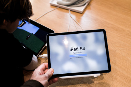 Male hand close-up of new Apple Computers iPad Air in storeのeditorial素材