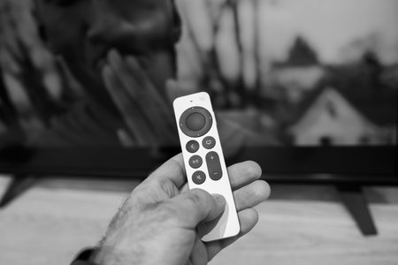 Male hand close-up of new Apple Computers Siri Remote voice recognition of new Apple TV 4K touch-enabled clickpadのeditorial素材