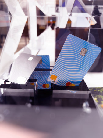 Close-up of Orange Bank card advertising on the dedicated showcase in telecommunication branch Storeのeditorial素材