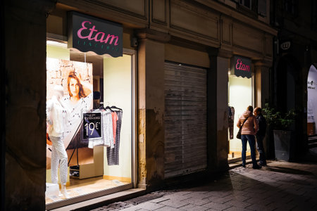 Etam French lingerie store at night with couple looking at the showcaseのeditorial素材