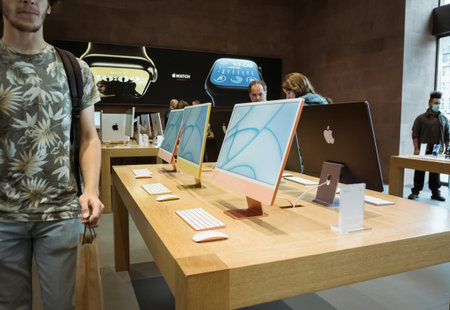 Customer walking near new iMac Apple Computers all-in-one Mac desktop computers designed and built...