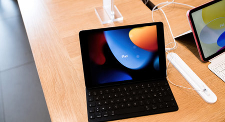iPad Air tablet personal computer by Apple Computers on table in Apple Store nest to Pencil charging...