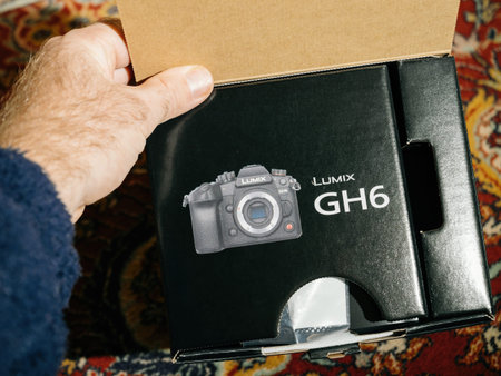 New Panasonic Lumix GH6 mirrorless camera package in male hand d