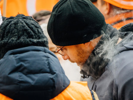 Side view of man marching smoking at second demonstration against the new pension reform to be presented next month by French Prime Minister Elisabeth Borneのeditorial素材
