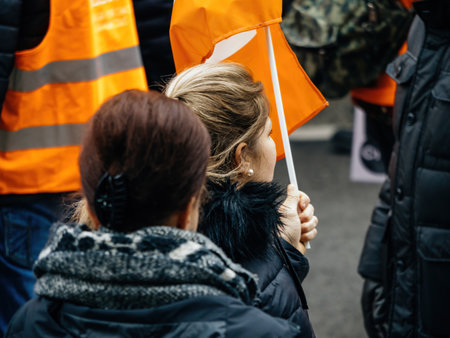 Rear view of woman holding flag at second demonstration against the new pension reform to be presented next month by French Prime Minister Elisabeth Borneのeditorial素材