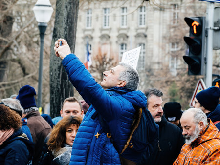 man taking photo with smartphone second demonstration against the new pension reform to be presented next month by French Prime Minister Elisabeth Borneのeditorial素材