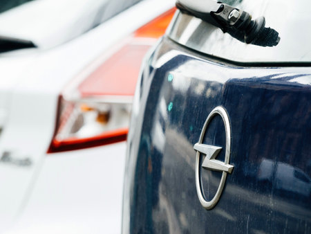 Chrome logotype of the Opel car brand on a blue car parked in ciのeditorial素材
