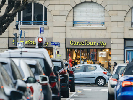 Perspective view through parked cars at the Carrefour City supermarket in city center of Strasbourgのeditorial素材