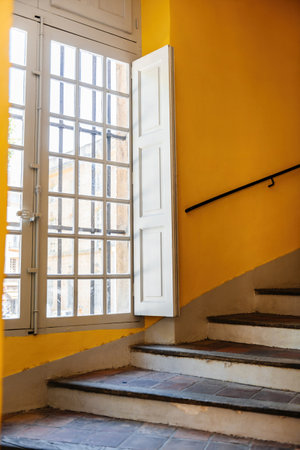 stairs staircase in old Hausmannian a building with large window covered with sunの写真素材