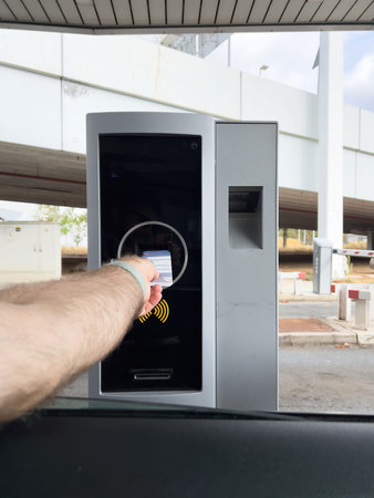 POV male driver hand inserting in parking meterの写真素材